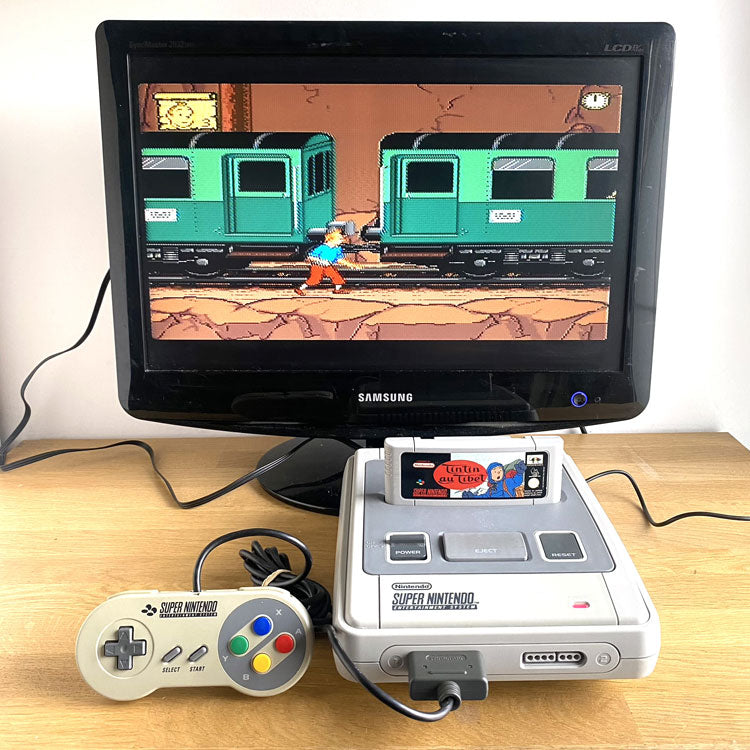 Console Super Nintendo avec manette + Jeu Tintin au Tibet